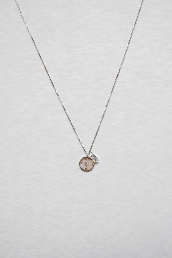 Necklace features a stunning sterling silver compass adorned with a clear quartz moon shape - rhodium plating