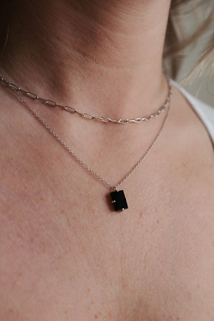 Double paperclip layered necklace with a 16-inch sterling silver chain and a glamorous black tourmaline pendant adorned in gold.