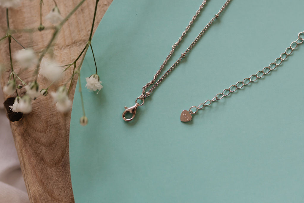 "Sterling silver heart tag affirmation necklace from I Am Love, featuring a lobster clasp for a meaningful and stylish accessory."