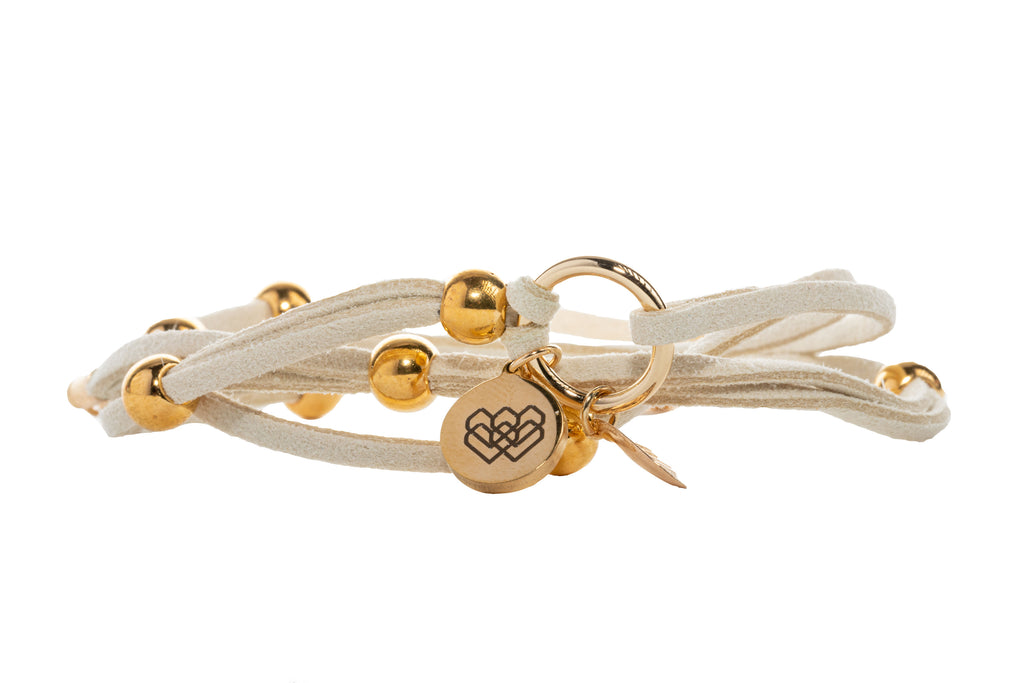 Strands of soft suede embellished with gold accents representing abundance and infinite love.
