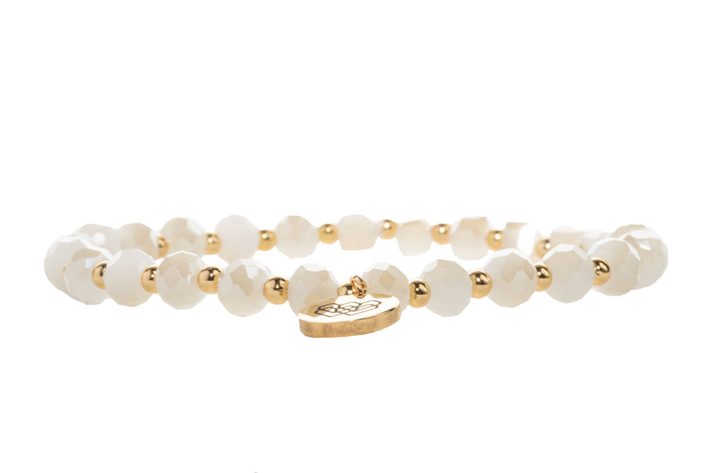 An I AM LOVE affirmation bracelet made with cream faceted beads and mini gold accents.