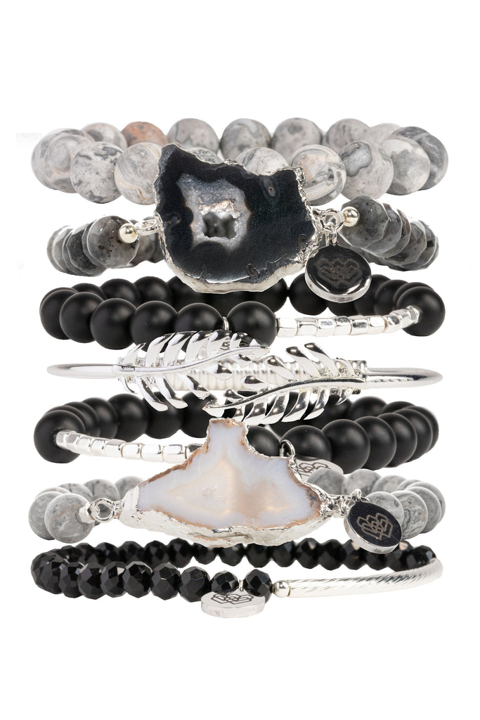 Featuring an exquisite blend of glass, agate, and matte picasso jasper beads, this edgy stunning bracelet collection