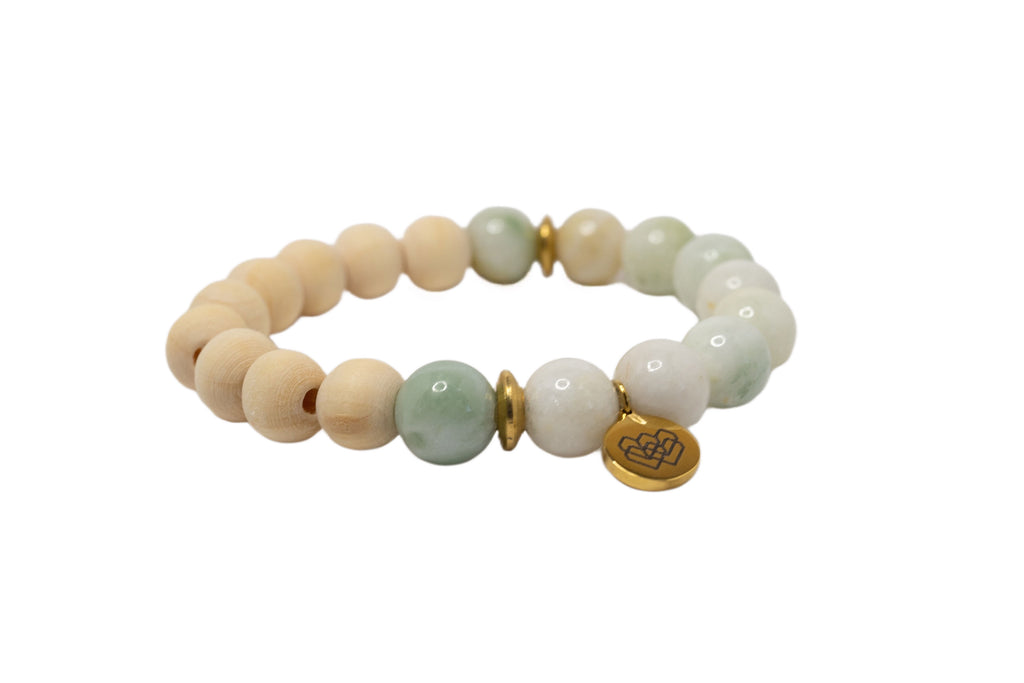 Image of a 10 mm quality jade beaded diffuser bracelet. The bracelet features round, smooth jade beads strung together on an elastic cord, suitable for use with essential oils for aromatherapy