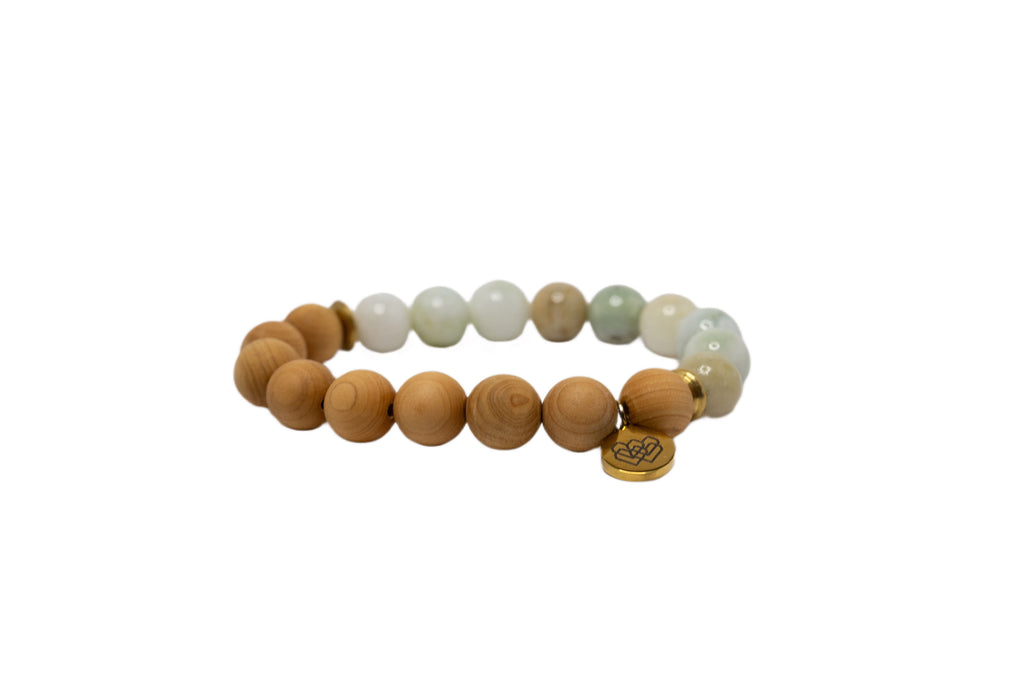Image of a 10 mm quality jade beaded sandalwood diffuser bracelet. The bracelet features round, smooth jade beads strung together on an elastic cord, suitable for use with essential oils for aromatherapy