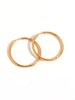 Gold rounded hoop earrings called Golden Glow Hoops by I Am Love
