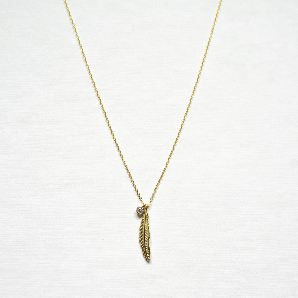 Exquisitely crafted from sterling silver and adorned with a delicate yet striking feather design and clear quartz necklace - gold 