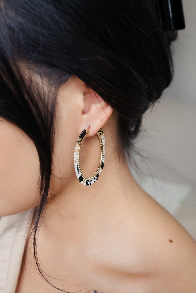 Embrace style and elegance with these handmade Delica beaded black hoops, featuring a stunning mix of gold, black, and white beads on a stainless steel hoop
