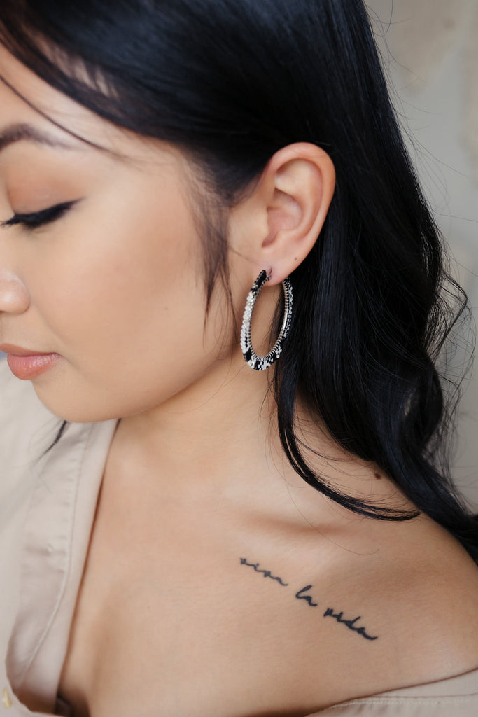 Handmade Delica beaded black hoops with a stylish mix of silver, black, and white beads on a stainless steel hoop