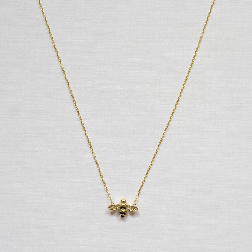 Sterling silver necklace with 14K gold plating. Small bee pendant featuring cubic zirconia accents on the wings