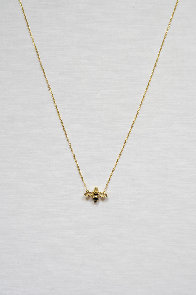Sterling silver necklace with 14K gold plating. Small bee pendant featuring cubic zirconia accents on the wings