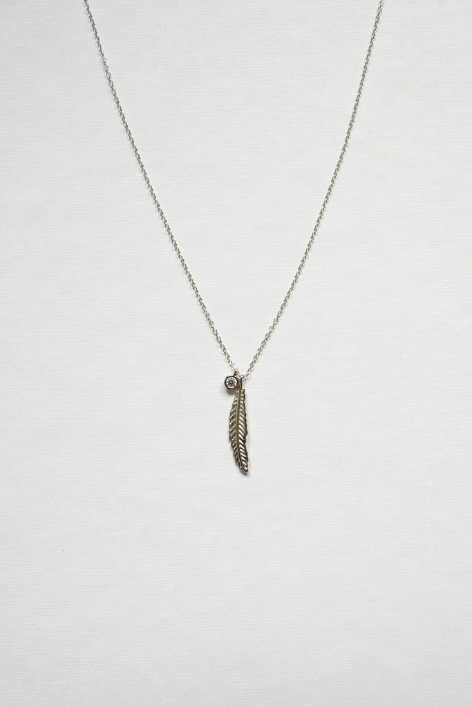 Exquisitely crafted from sterling silver and adorned with a delicate yet striking feather design and clear quartz necklace -silver