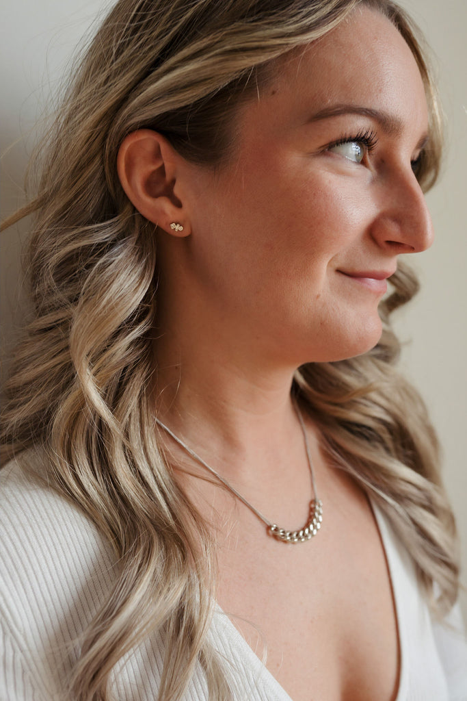A striking sterling silver necklace with double strands. The center showcases ten larger link chains elegantly intertwined, creating a bold and stylish focal point. The sleek silver shine and intricate design make it a captivating and versatile accessory.