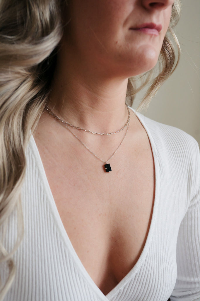 Double paperclip layered necklace with a 16-inch sterling silver chain and a glamorous black tourmaline pendant adorned in gold.