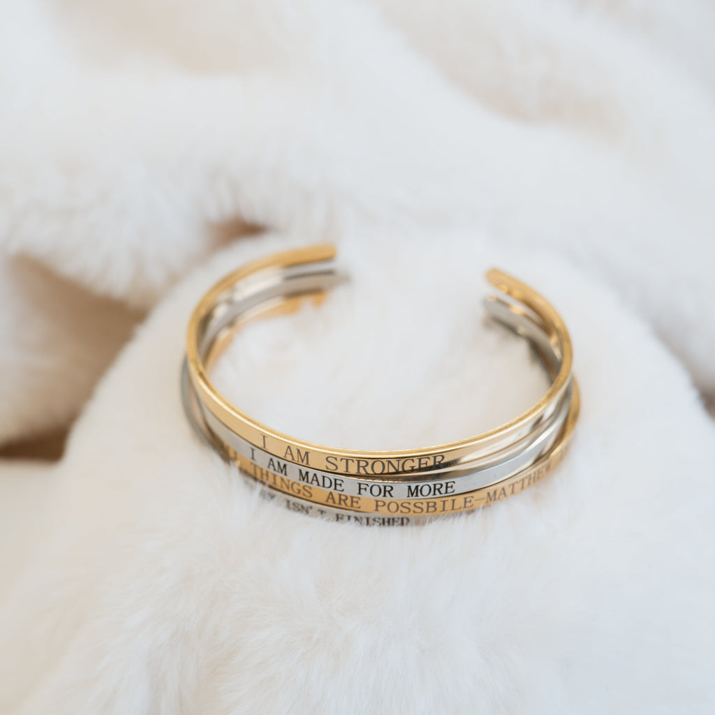 gold and silver bangles engraved with affirmations