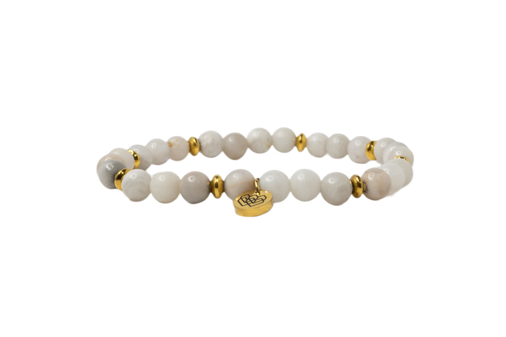 White lace agate bracelet featuring gold spacers and a circular charm with the 'I Am Love' logo.