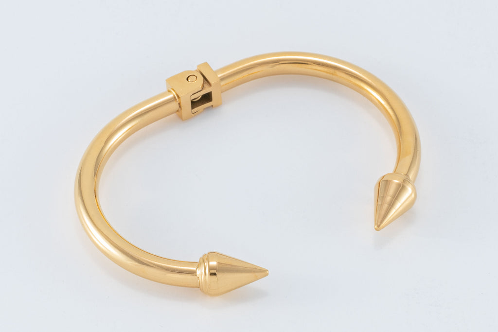 Shine brighter than a golden compass with this 14K gold plated cuff bangle