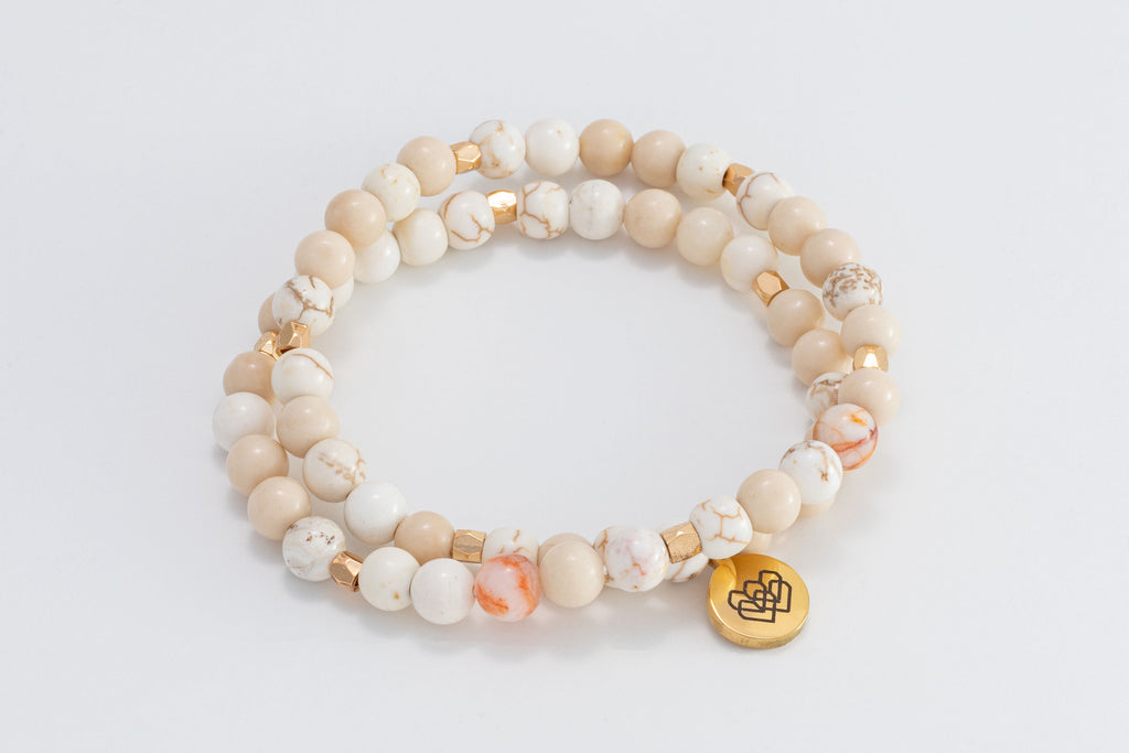 Fossil Wood beaded wrap intention bracelet with subtle accenting of pink and white beads.