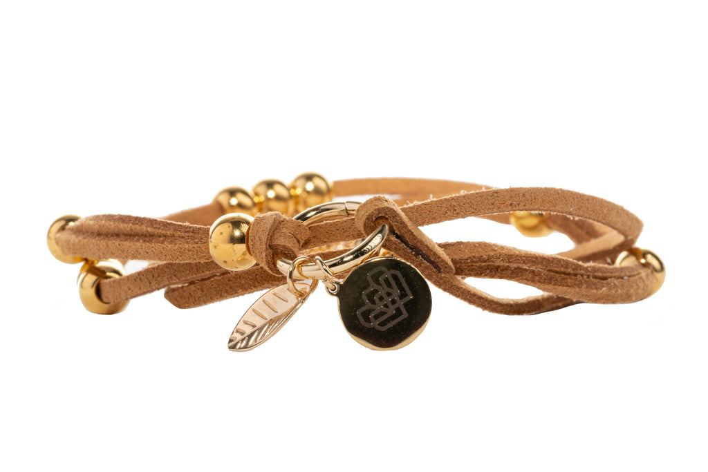 Strands of tan suede embellished with gold accents representing abundance and infinite love.