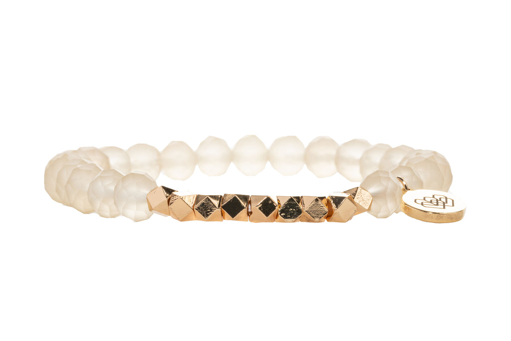 A graceful affirmation bracelet adorned with mini gold faceted beads and luxurious tawny bisque glass beads with I AM LOVE charm