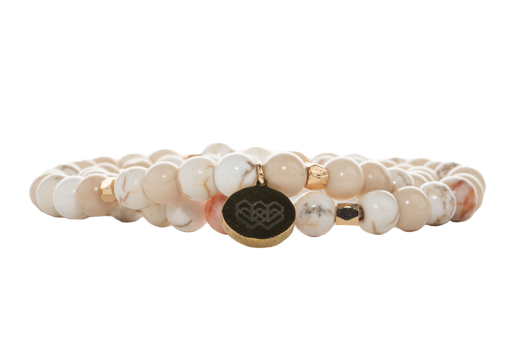 Off-white 6mm Fossil Wood beaded double wrap intention bracelet with subtle accenting of pink and white beads.