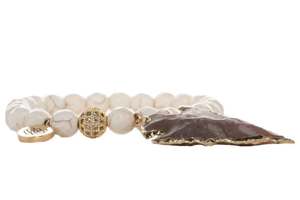 This bracelet features creamy howlite, shining cubic zirconia, and a gorgeous brown agate arrow