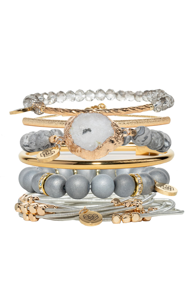 Through Generosity Bracelet Collection! Featuring 6 beautiful bangles, agate, picasso jasper, glass beads, and geodes, this shimmery grey and gold-tone bracelet will spark your spirit with the reminder to be compassionate and open-hearted. 